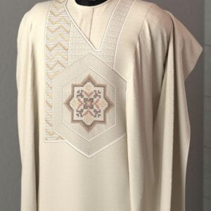 Cream-colored agbada with elegant geometric embroidery in soft gold and brown tones.