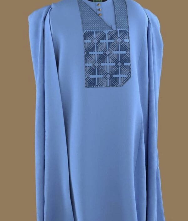 Sky-blue agbada featuring detailed embroidery on the chest in a geometric pattern.