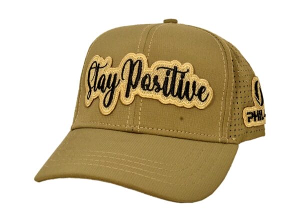 Beige cap with "Stay Positive" embroidered in black.