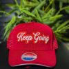 Red cap with "Keep Going" embroidered in white.