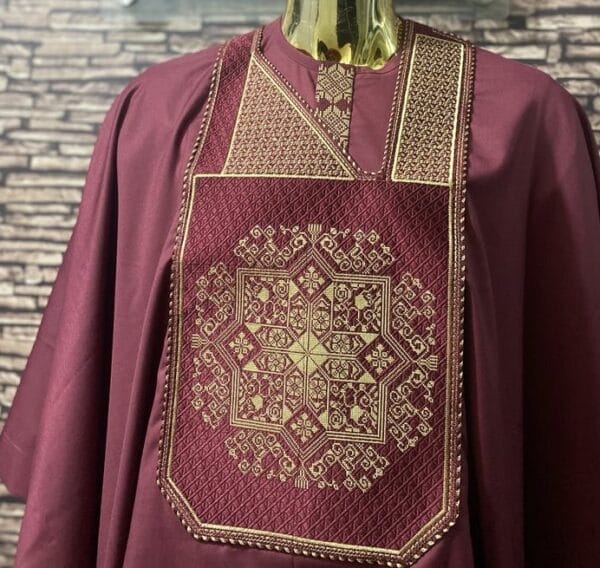 Burgundy agbada with beautiful gold embroidery on the front, featuring unique patterns.